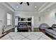 Open-concept living room with a view to the kitchen, hardwood floors, and a comfortable leather sofa at 2705 Fox Hunt Way, Cumming, GA 30041
