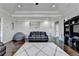 A cozy living room featuring hardwood floors, tray ceilings, and a plush gray rug at 2705 Fox Hunt Way, Cumming, GA 30041