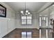 Bright living room features hardwood floors, wainscoting, and modern lighting at 2705 Fox Hunt Way, Cumming, GA 30041