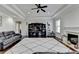 Spacious living room features a fireplace, tray ceiling and dark hardwood floors at 2705 Fox Hunt Way, Cumming, GA 30041