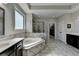 Luxurious main bathroom with soaking tub, shower, and double vanity with great lighting at 2705 Fox Hunt Way, Cumming, GA 30041