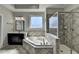 Clean main bathroom featuring a large tub, walk-in shower, and plenty of natural light at 2705 Fox Hunt Way, Cumming, GA 30041