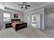 Bright main bedroom features a ceiling fan, natural light, and access to the main bathroom at 2705 Fox Hunt Way, Cumming, GA 30041