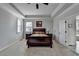 Comfortable main bedroom with a tray ceiling, natural light, and easy access to the main bathroom at 2705 Fox Hunt Way, Cumming, GA 30041