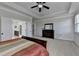 The main bedroom features a ceiling fan, dresser, and easy access to the main bathroom and closet at 2705 Fox Hunt Way, Cumming, GA 30041