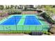 Community tennis courts with green and blue surface, enclosed by a fence, providing a recreational amenity at 2705 Fox Hunt Way, Cumming, GA 30041