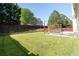 Beautiful backyard with lush green grass, a patio area, and a swing for relaxation at 2984 Gayle Manor Ln, Snellville, GA 30078