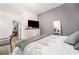 Bedroom with TV, mirror, neutral walls, and decorative elements, offering a relaxing and stylish space at 2984 Gayle Manor Ln, Snellville, GA 30078