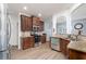 Modern kitchen with stainless steel appliances, granite countertops, and dark wood cabinets at 2984 Gayle Manor Ln, Snellville, GA 30078
