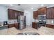 Modern kitchen with stainless steel appliances, granite countertops, and dark wood cabinets at 2984 Gayle Manor Ln, Snellville, GA 30078
