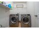 Functional laundry room equipped with modern washing machines and storage, ensuring efficient laundry tasks at 2984 Gayle Manor Ln, Snellville, GA 30078