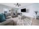 Spacious living room boasts a fireplace, large sectional sofa, and a modern ceiling fan at 2984 Gayle Manor Ln, Snellville, GA 30078