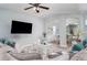 Cozy living room features plush seating, stylish decor, and a ceiling fan for added comfort at 2984 Gayle Manor Ln, Snellville, GA 30078