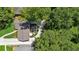 Aerial shot of a home nestled among mature trees with a patio, driveway, and manicured lawn at 389 Valley Brook Ne Dr, Atlanta, GA 30342