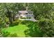 Aerial view of a spacious backyard, house, and driveway surrounded by mature trees at 389 Valley Brook Ne Dr, Atlanta, GA 30342
