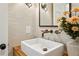 This half bathroom features textured wallpaper, rustic vanity, bronze fixtures, and a decorative mirror at 389 Valley Brook Ne Dr, Atlanta, GA 30342