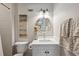 Well-lit bathroom features modern fixtures, stylish mirror, and white tiling at 389 Valley Brook Ne Dr, Atlanta, GA 30342