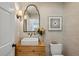 This half bathroom features textured wallpaper, rustic vanity, geometric artwork, and decorative lighting at 389 Valley Brook Ne Dr, Atlanta, GA 30342