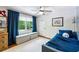 This cozy bedroom features a ceiling fan, hardwood floors, and a window with peaceful views at 389 Valley Brook Ne Dr, Atlanta, GA 30342
