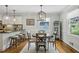 Dining area featuring hardwood floors, a modern light fixture, and a large window at 389 Valley Brook Ne Dr, Atlanta, GA 30342