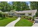 Charming home with a well-maintained front yard, walkway, and beautiful landscaping at 389 Valley Brook Ne Dr, Atlanta, GA 30342