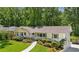 Charming single-story home with a well-manicured lawn, white painted brick, and a walkway leading to the front door at 389 Valley Brook Ne Dr, Atlanta, GA 30342