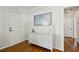 Hallway featuring hardwood floors, neutral paint, console table, and contemporary light fixture at 389 Valley Brook Ne Dr, Atlanta, GA 30342