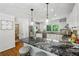 A spacious kitchen island features black countertops, white cabinets, and stainless steel appliances at 389 Valley Brook Ne Dr, Atlanta, GA 30342