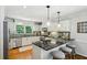 Modern kitchen with white cabinets, granite countertops, stainless steel appliances, and pendant lighting at 389 Valley Brook Ne Dr, Atlanta, GA 30342