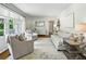 Bright living room featuring hardwood floors, neutral paint, stylish furniture, and a large window at 389 Valley Brook Ne Dr, Atlanta, GA 30342