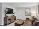 Cozy living room includes a television, leather sofa, ottoman, and modern decor at 389 Valley Brook Ne Dr, Atlanta, GA 30342