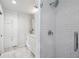 A bright main bathroom features a glass door shower, marble floors, and white cabinets for storage at 389 Valley Brook Ne Dr, Atlanta, GA 30342