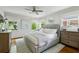 This bright and airy main bedroom features light-colored walls, hardwood floors, and soft, natural lighting at 389 Valley Brook Ne Dr, Atlanta, GA 30342