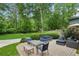 Outdoor patio with seating, lush landscaping, and a well-maintained lawn at 389 Valley Brook Ne Dr, Atlanta, GA 30342