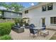 Brick patio with modern outdoor furniture, dining table, and an umbrella for shade at 389 Valley Brook Ne Dr, Atlanta, GA 30342