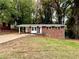 Cozy brick house with a carport and a compact front yard surrounded by lush trees at 398 Windy Hill Se Rd, Marietta, GA 30060
