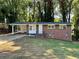 Charming brick home featuring a covered carport and well-manicured front lawn at 398 Windy Hill Se Rd, Marietta, GA 30060