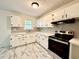 Bright kitchen featuring white cabinets, a modern tile backsplash, and stainless steel appliances at 398 Windy Hill Se Rd, Marietta, GA 30060