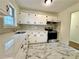 Modern kitchen with granite counters, stainless appliances, and marble tile flooring at 398 Windy Hill Se Rd, Marietta, GA 30060