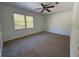 Spacious bedroom featuring neutral carpet, a ceiling fan, and a window offering ample natural light at 4485 Golf Vista Cir, Decatur, GA 30035