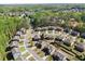 An aerial view of a suburban neighborhood featuring tree-lined streets and well-maintained homes at 4735 Belcrest Way, Cumming, GA 30040