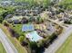 Community pool and tennis courts from above surrounded by landscaped areas at 4735 Belcrest Way, Cumming, GA 30040