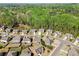 Panoramic aerial view highlighting the community's layout nestled among dense greenery at 4735 Belcrest Way, Cumming, GA 30040