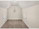 Finished attic boasts neutral walls, carpet, and two storage access doors at 4735 Belcrest Way, Cumming, GA 30040