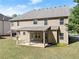 Side view of the home's backyard featuring a covered patio with direct access to the green space at 4735 Belcrest Way, Cumming, GA 30040