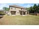 Spacious backyard with a covered patio, lush green grass, and a two-story home at 4735 Belcrest Way, Cumming, GA 30040