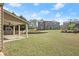 Expansive backyard with a covered patio, bordered by a charming wooden fence and lush trees at 4735 Belcrest Way, Cumming, GA 30040