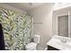 Clean bathroom with a sink, toilet, and a vibrant shower curtain at 4735 Belcrest Way, Cumming, GA 30040
