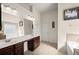 Bright bathroom with double sink vanity, large mirror, and a separate soaking tub at 4735 Belcrest Way, Cumming, GA 30040