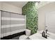 Stylish bathroom featuring a white vanity, striped shower curtain, and a green patterned wallpaper at 4735 Belcrest Way, Cumming, GA 30040